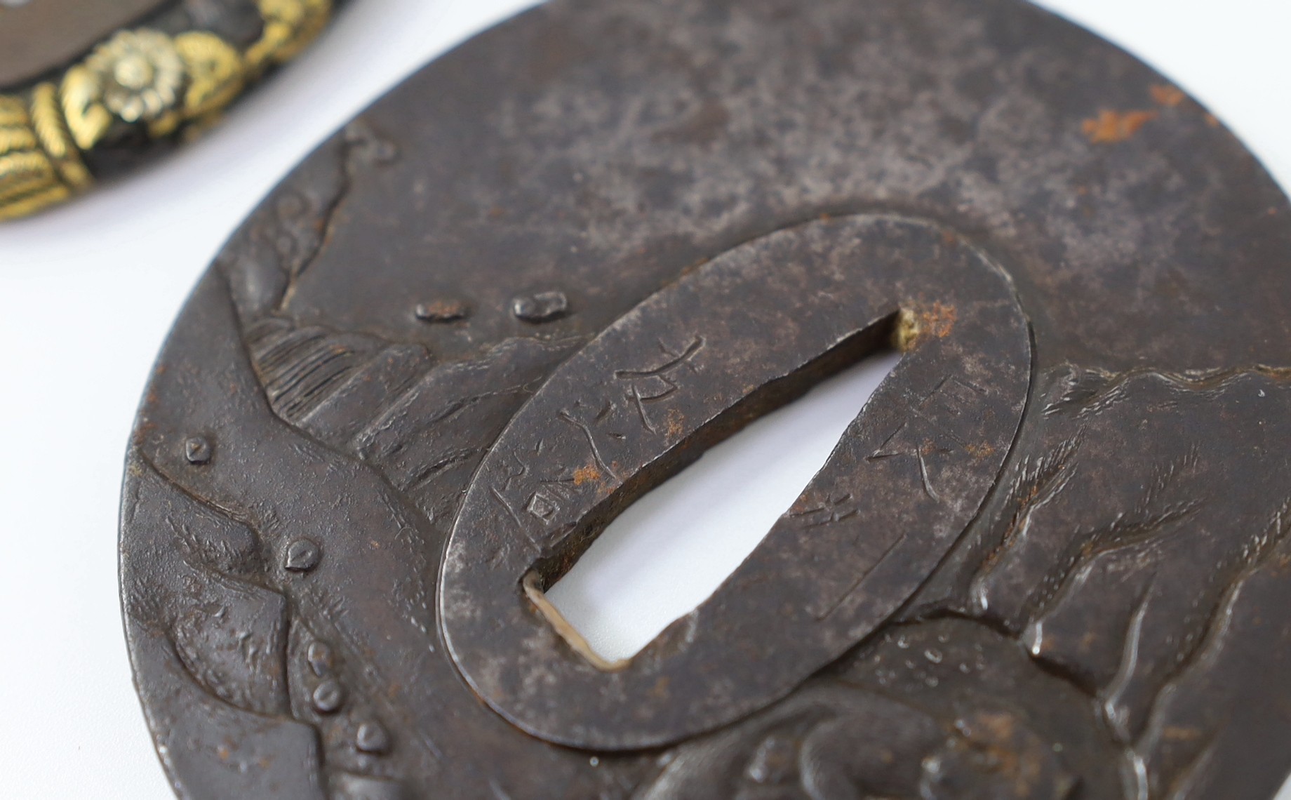 A group of Japanese bronze, iron and mixed metal tsuba and a kozuka knife handle, 19th century